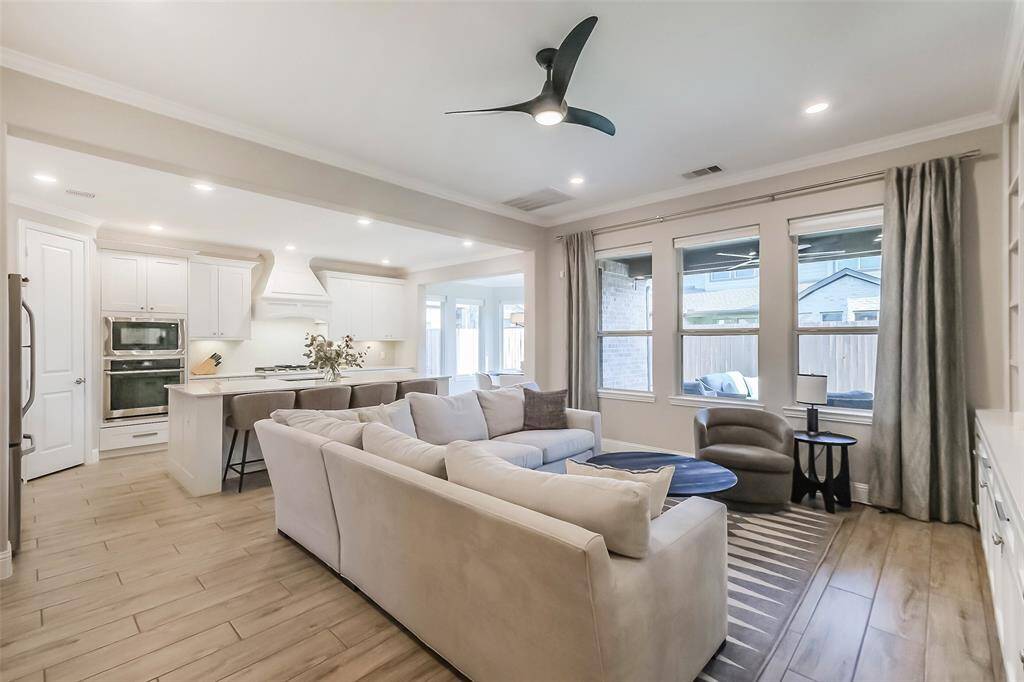 The kitchen in the main residence is spacious, bright and open. Notice the oversized kitchen island with commercial style pull-down faucet.