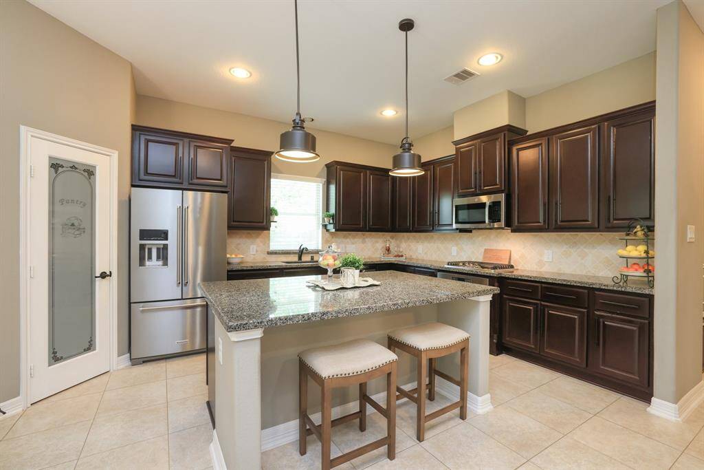 Gorgeous kitchen with plenty of cabinets and walk in pantry