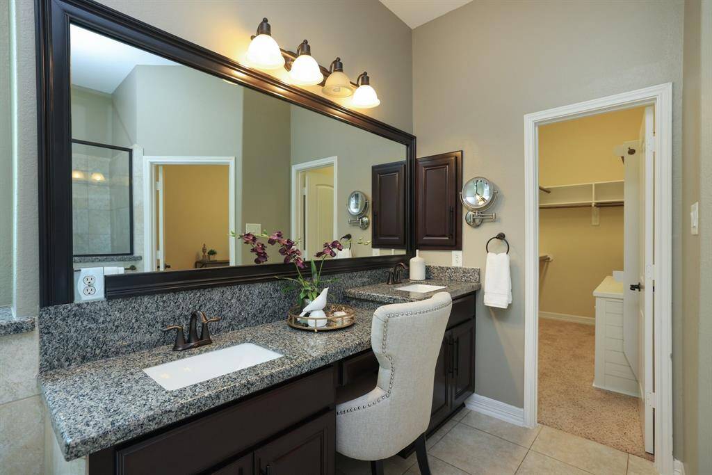 Primary bath with dual sinks and built in vanity.  Large walk in closet