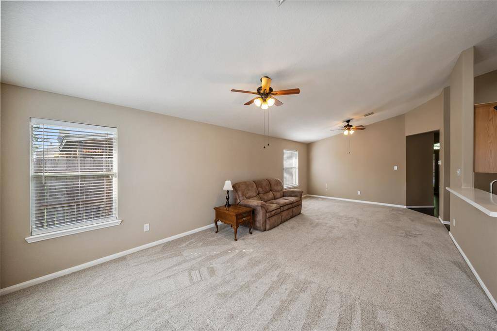The ideal setting for movie nights, casual gatherings, or everyday relaxation, this expansive family room features a vaulted ceiling, a warm neutral color palette, and great natural light. With seamless access to the kitchen and dining area, it’s perfectly designed for both entertaining and easy day-to-day living.