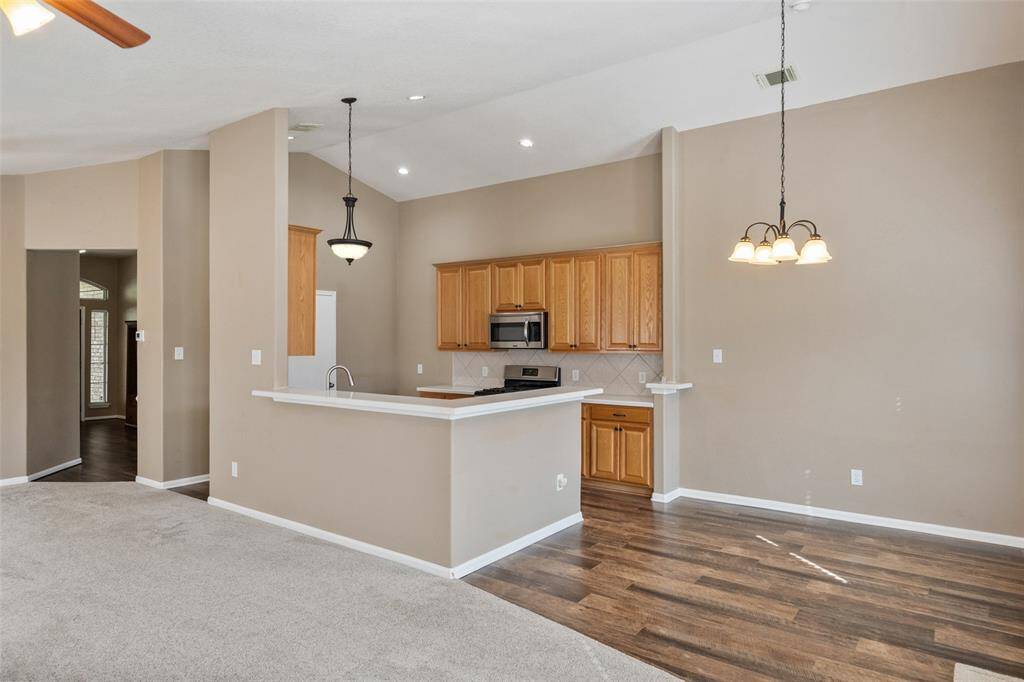 The kitchen is anchored by a wraparound bar that separates it from the family room and casual dining area. It’s ideal for serving snacks and drinks or add barstools to create a relaxed dining space.