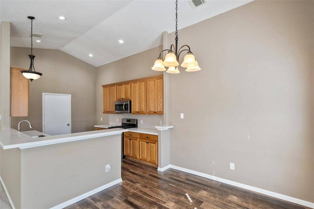 Open and inviting, this casual dining area and pristine kitchen set the stage for everything from romantic candlelit dinners to lively pizza nights with friends and family.