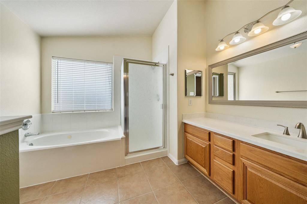 Enjoy everyday luxury in this elegant ensuite, complete with a relaxing jetted tub, a separate walk-in shower, and an extended vanity creating the perfect space to relax, refresh, and unwind.