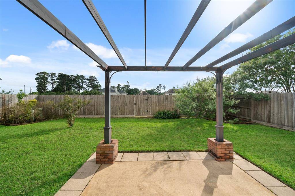 Bring your design ideas to life in this sunny backyard, where a pergola-style frame sets the stage for your dream outdoor setup. With direct gated access to a peaceful greenbelt and a walking trail that leads to the neighborhood park and pool, it’s a great spot to unwind, play, or entertain.