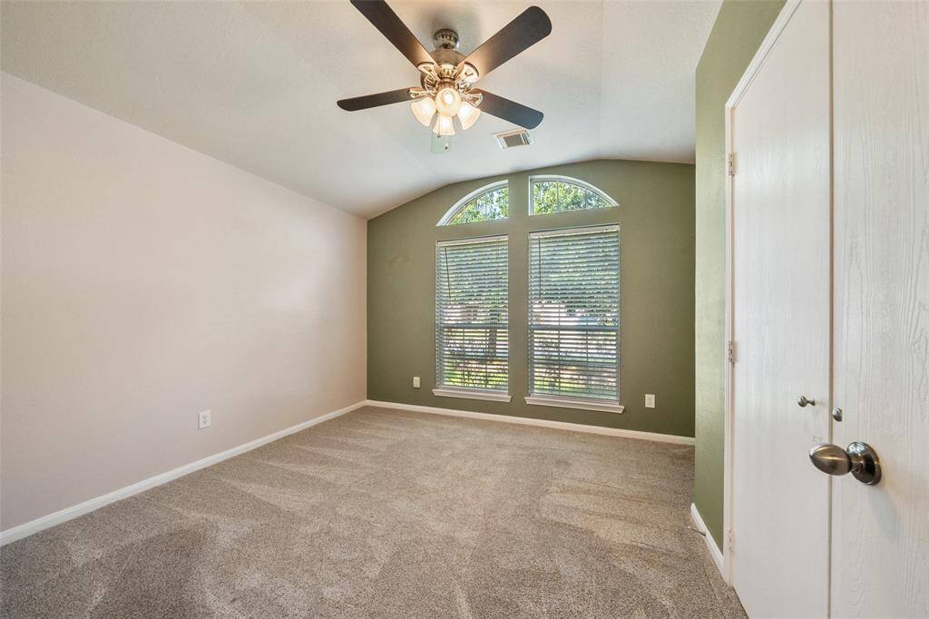 Your family and guests will rest comfortably in this spacious guest room with plush carpet, neutral/designer paint, arched windows, a large closet and easy access to a full bathroom.
