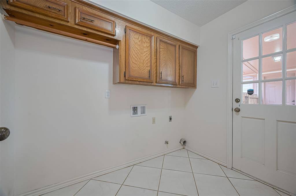 The utility room (8.3 x 6.0) offers both function and flexibility, with space for a full-size washer and dryer plus room for an upright freezer or second refrigerator. It’s plumbed for either an electric or gas dryer to suit your needs. Upper cabinets provide extra storage for cleaning supplies or laundry essentials. A door leads to the covered breezeway, making trips to and from the garage a breeze—rain or shine.