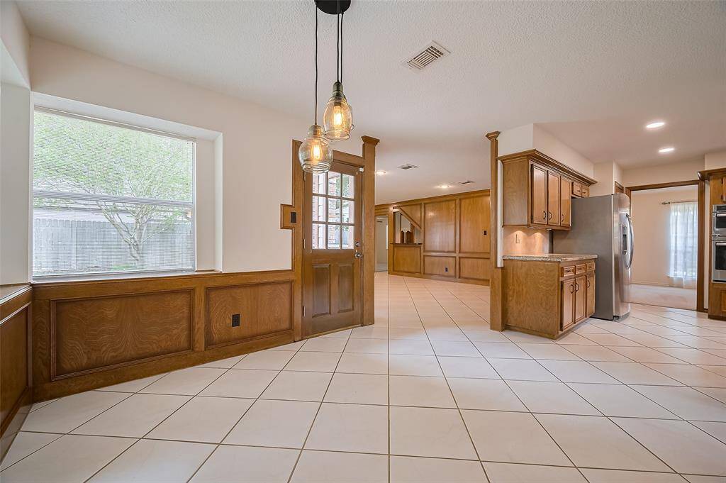 A door from the breakfast room opens to the patio and backyard—perfect for those who love to grill or entertain outdoors, with easy access to bring meals straight into the kitchen. The breakfast room seamlessly flows into the spacious family room, creating a sense of connection that’s ideal for everyday living.