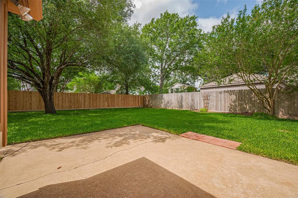 Two windows from the breakfast room offers a view of the patio, where a walkway connects to both back doors and the detached garage. The fully fenced backyard provides plenty of space for kids and the family dog to run and play. For added peace of mind, the wood privacy fencing was updated—left and right sides in 2023, and the rear in 2025—ensuring both security and curb appeal.