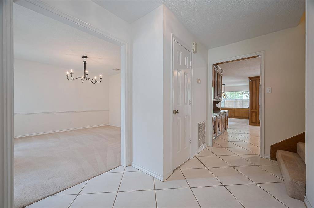 Foyer features a coat closet for added storage, with tile flooring that continues seamlessly into the family room, kitchen, and breakfast areas—offering both style and easy maintenance.