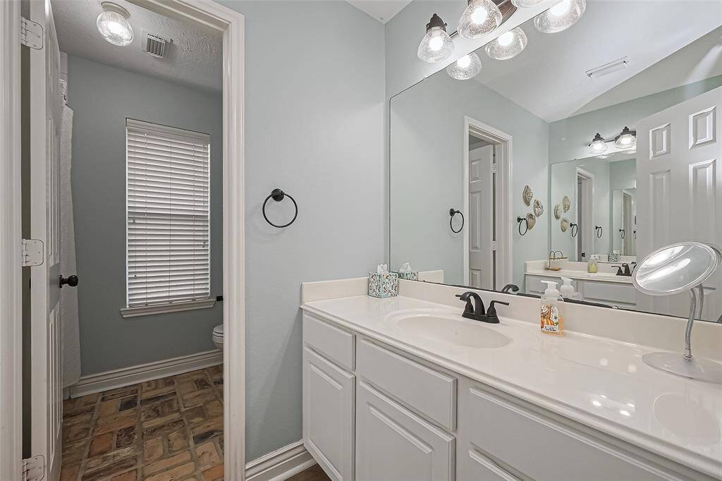 Guest bathroom with dual vanities on opposite walls