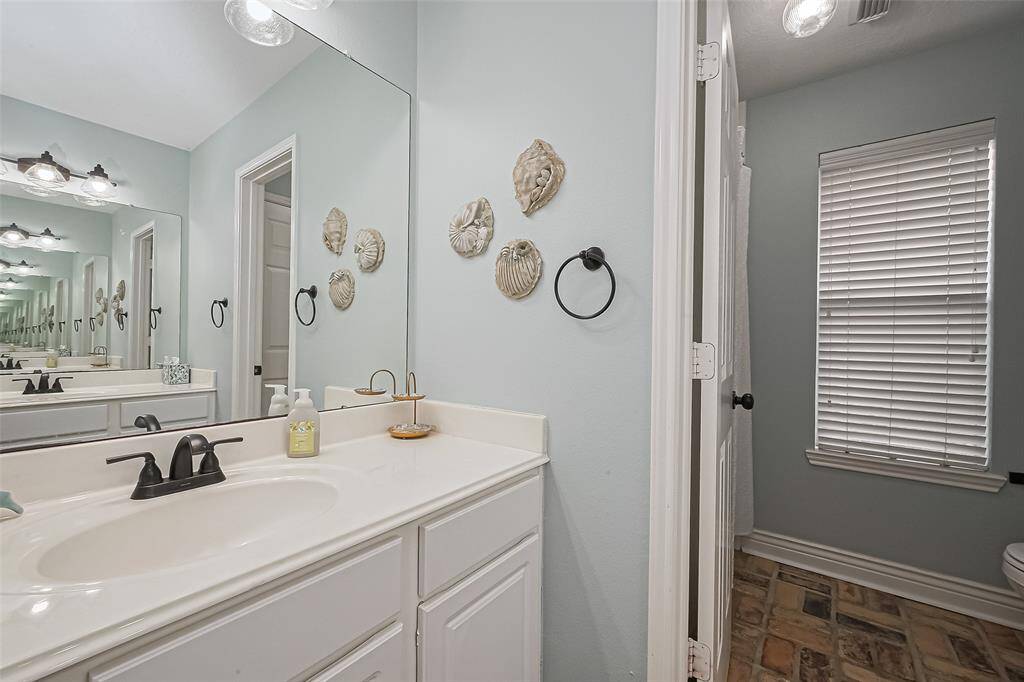 Guest bathroom with dual vanities on opposite walls