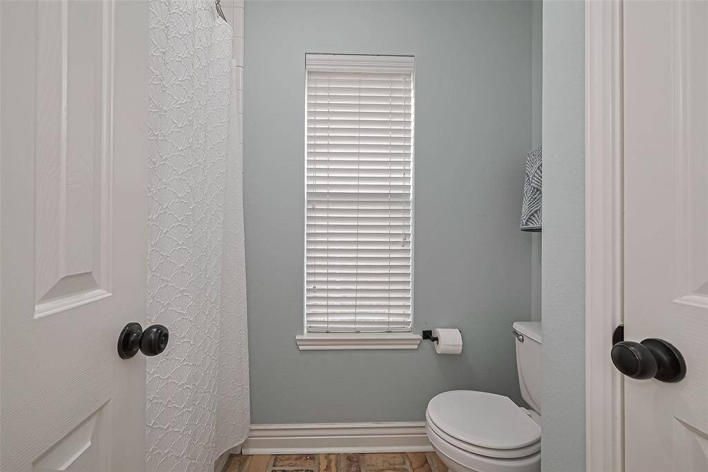 Guest bathroom with dual vanities on opposite walls