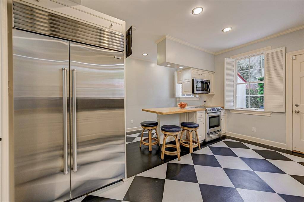 Kitchen was remodeled in 1990 with abundant storage, a dining banquette and windows overlooking back garden and guest house.