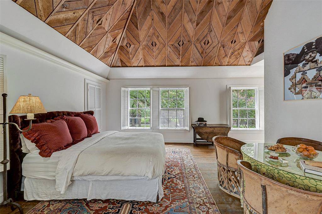 Luxurious primary suite is a private retreat with windows facing North Blvd.