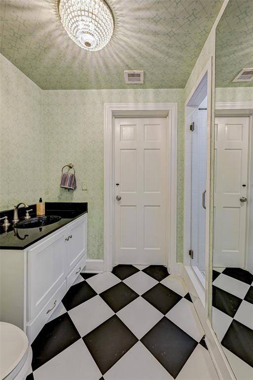 Bathroom with remodeled shower and a door leading to a second bathroom