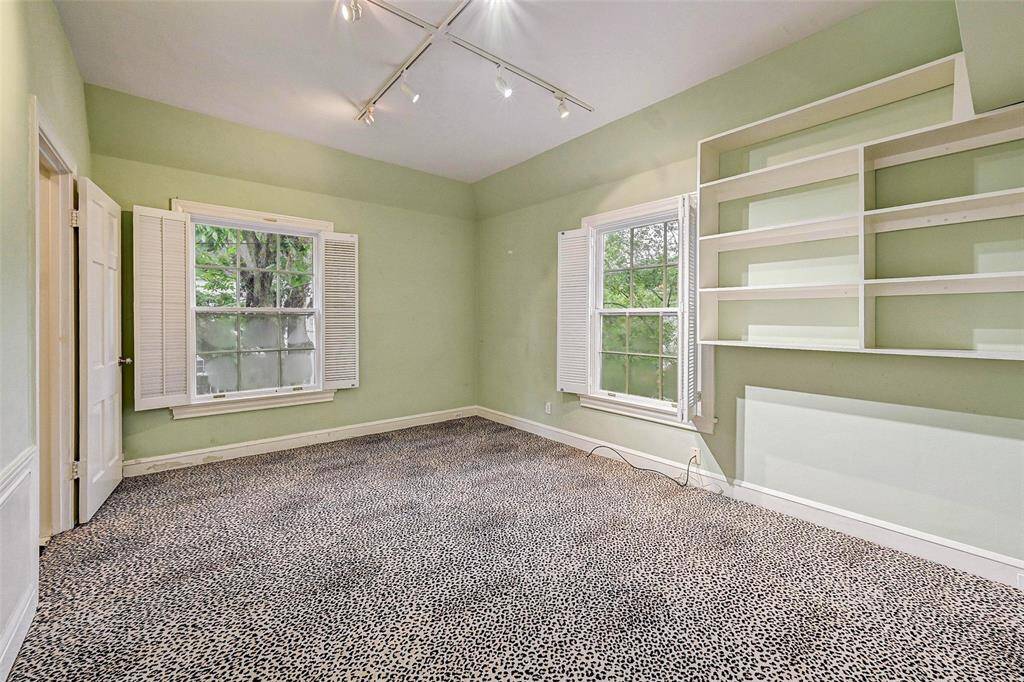 Bedroom with built in bookshelves and ensuite bath with tub.