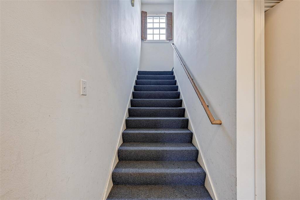 First floor laundry area next to stairway up to second floor bedrooms and bath