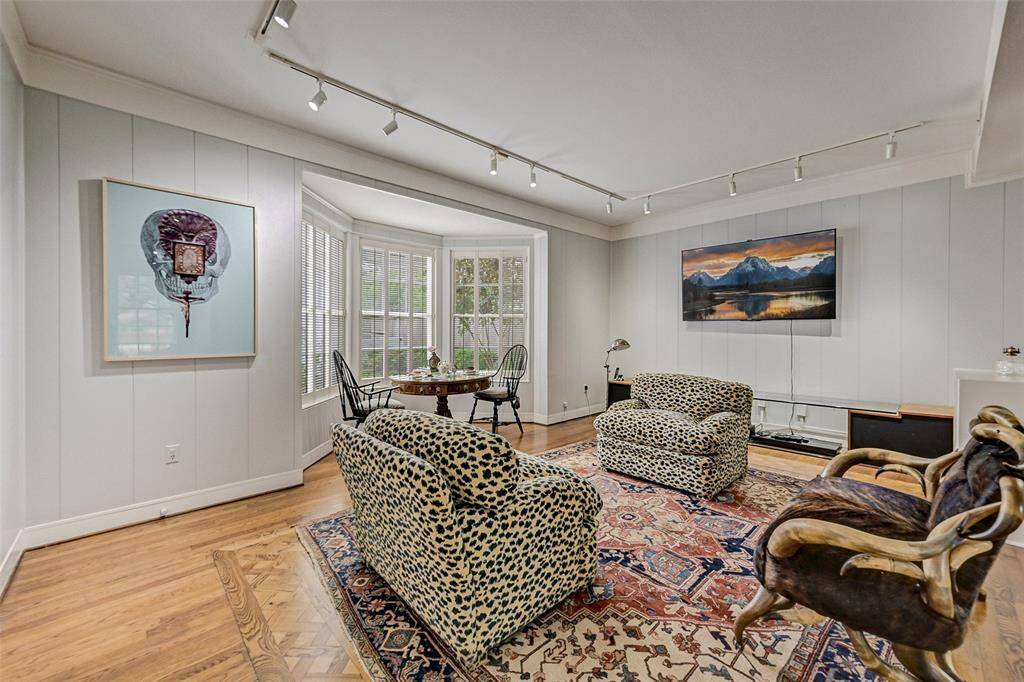 Adjacent to the living room is a comfortable den with Bay windows. A delightful setting  for coffee in the morning or tea in the afternoon.