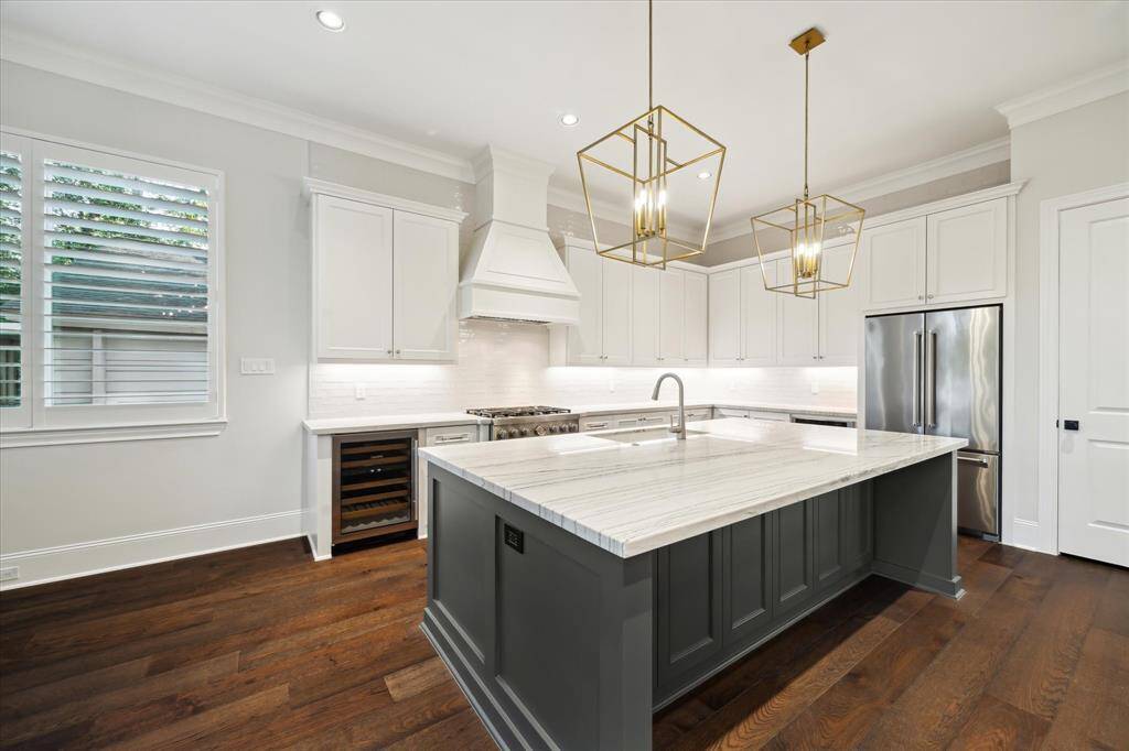 High-end Kitchen-aid appliances, a wine fridge and custom countertops make this kitchen the envy of the neighborhood.