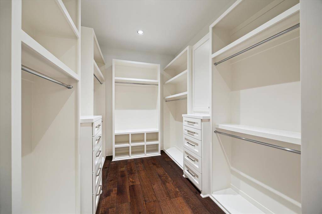 A spacious primary suite walk-in custom closet with plenty of room for your favorite shoes, outfits and clothes of different seasons make for a perfectly organized day!