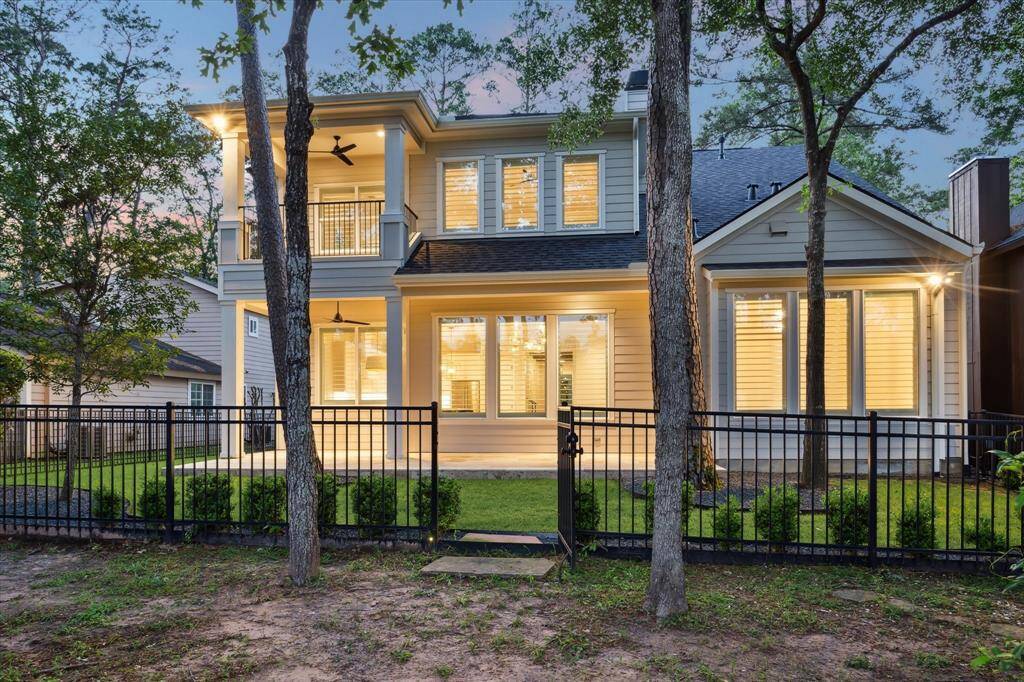 A refined iron fence with gate surrounds the property creating even more privacy.