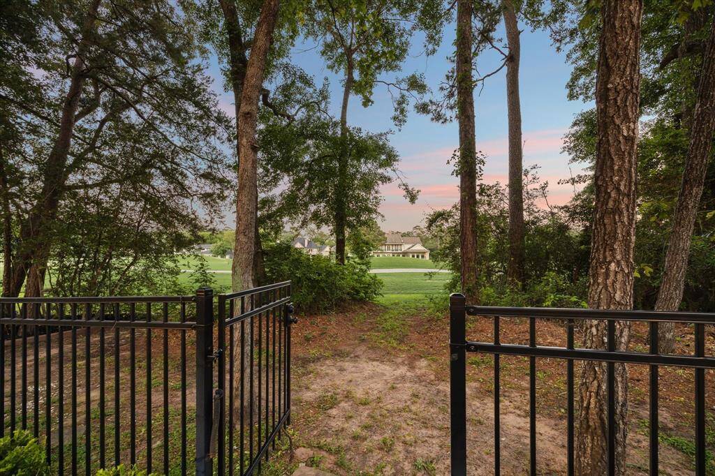 The gate in the back of the property opens to the wooded area next of the golf course.