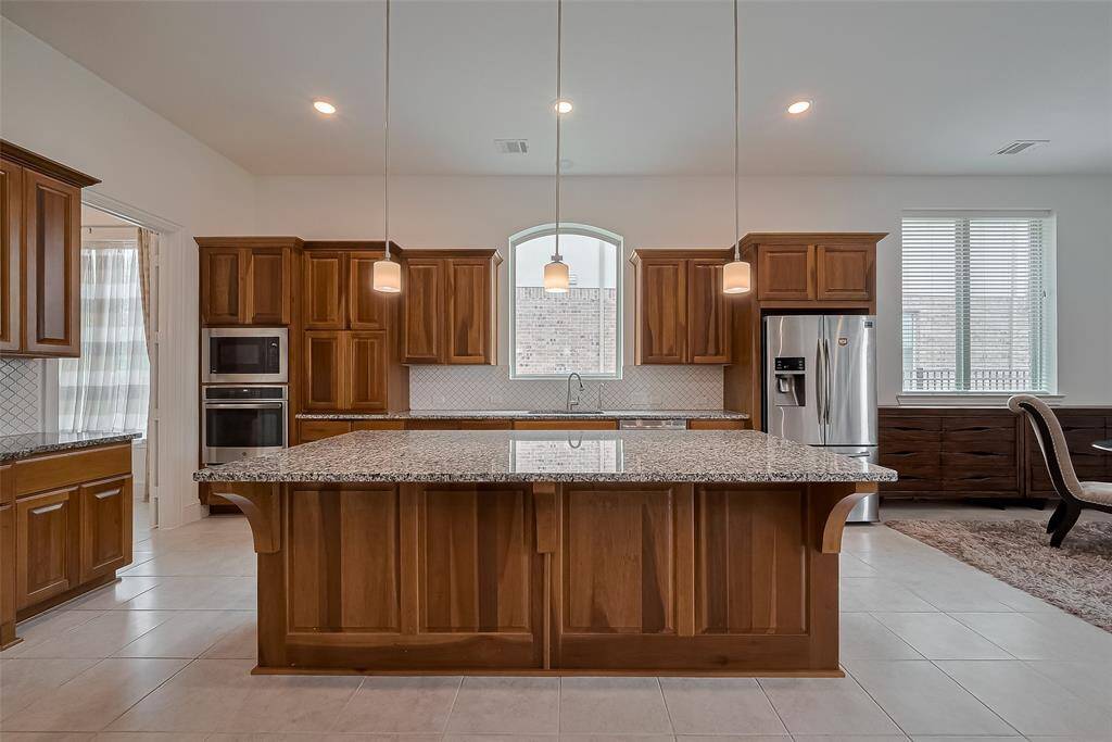 Gourmet Kitchen, huge center island with wood detailing.