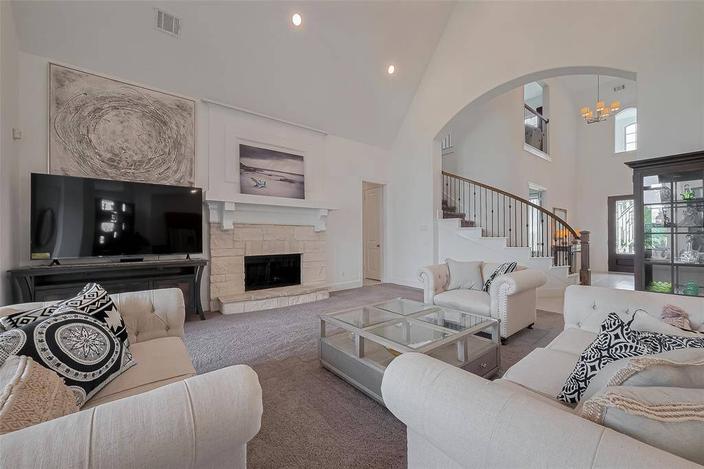 Open concept family room with soaring ceilings.
