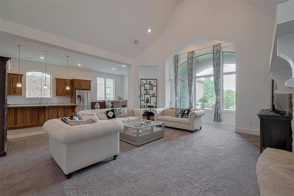 Large window with a view of the covered backyard patio.