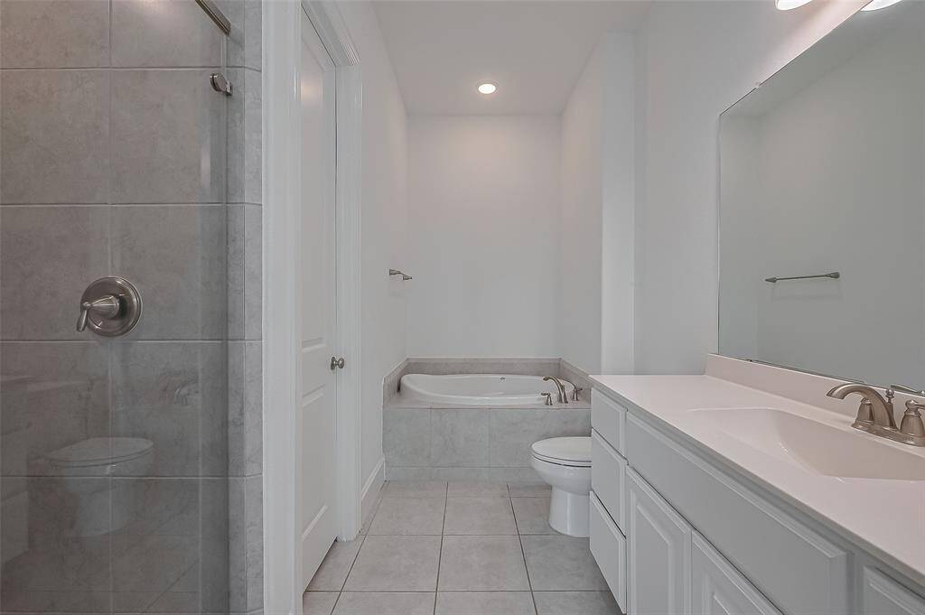 Primary 2 ensuite with walk-in shower, soaking tub, and vanity.