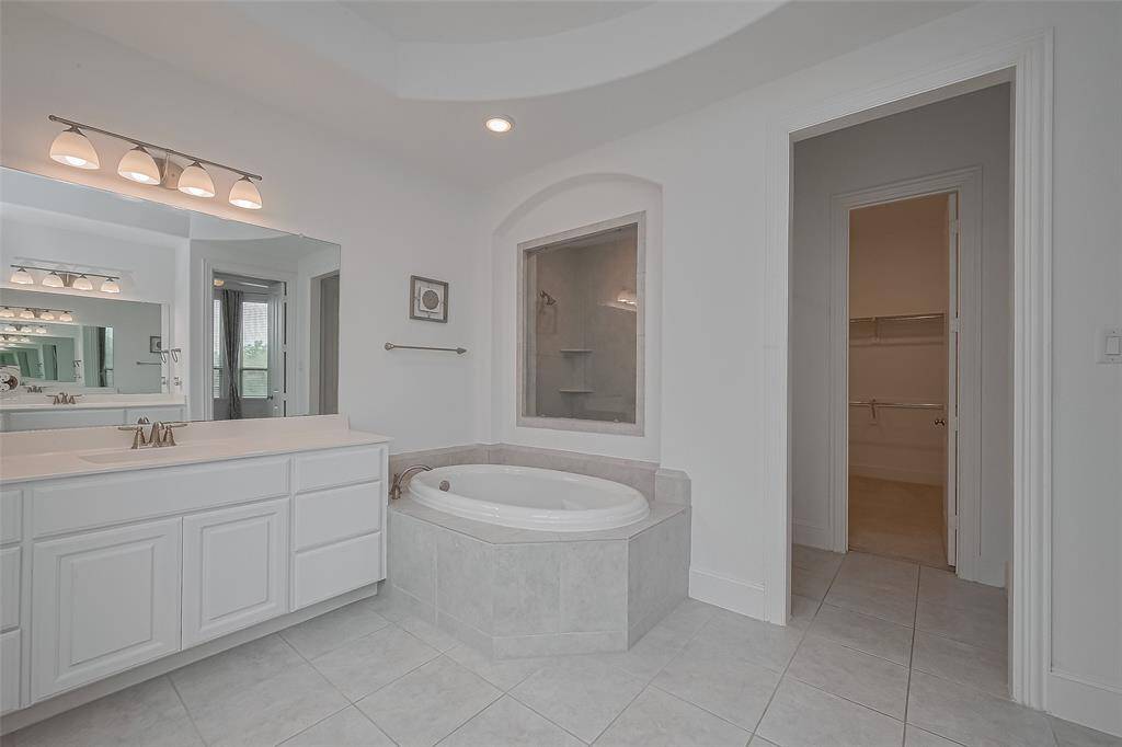 Primary 1 Ensuite- corner soaking tub, double vanity, and huge walk-in framless shower.