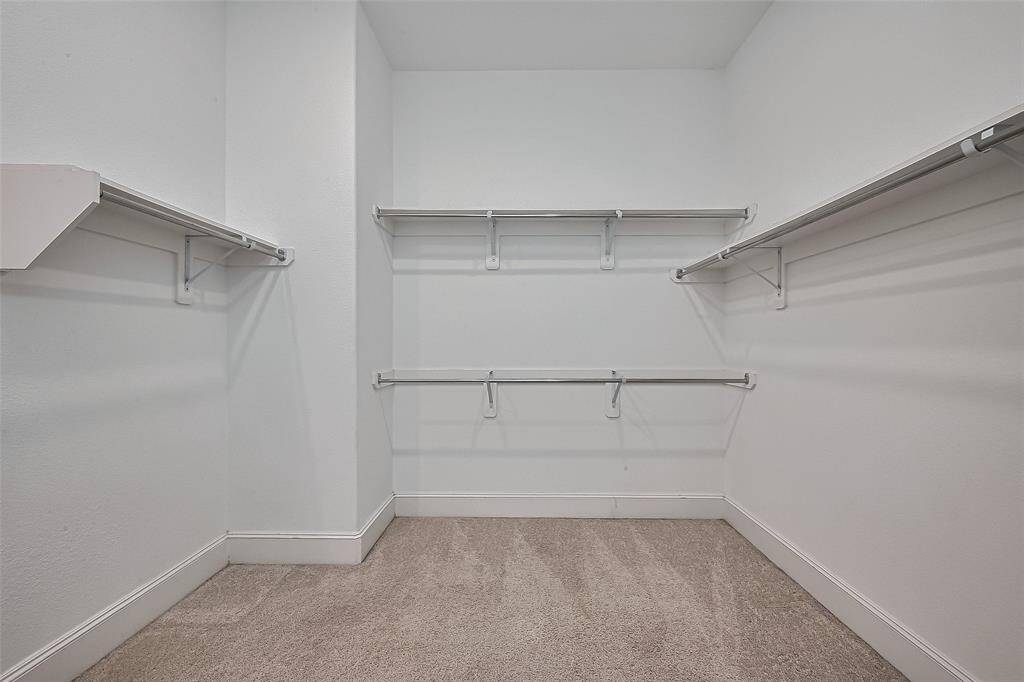 Primary 1 closet- plenty of hanging space and shelves for storage.