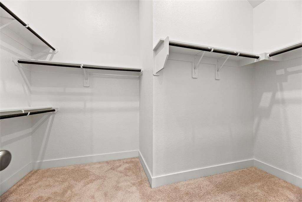The primary closet provides generous space to store your entire wardrobe while keeping everything neatly organized and easily accessible.