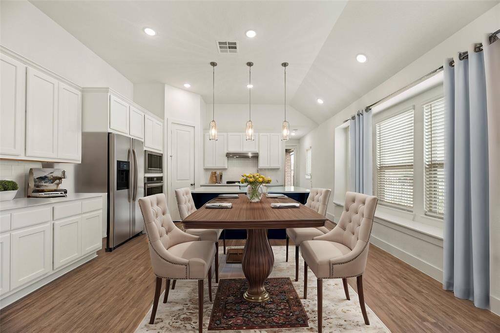 The dining room is ideal for a full-sized table and features easy care tile floors, large bright windows, and recessed lighting.