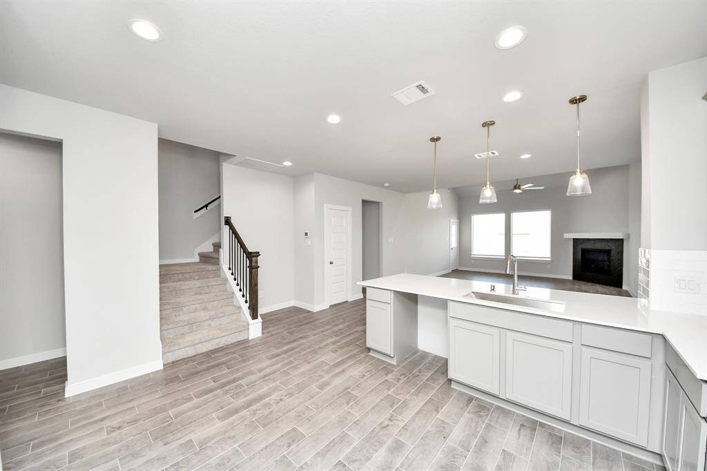 All of this overlooks your expansive family room, creating a perfect space for culinary delights and family gatherings. Sample photo of completed home with similar floor plan. Actual colors and selections may vary.