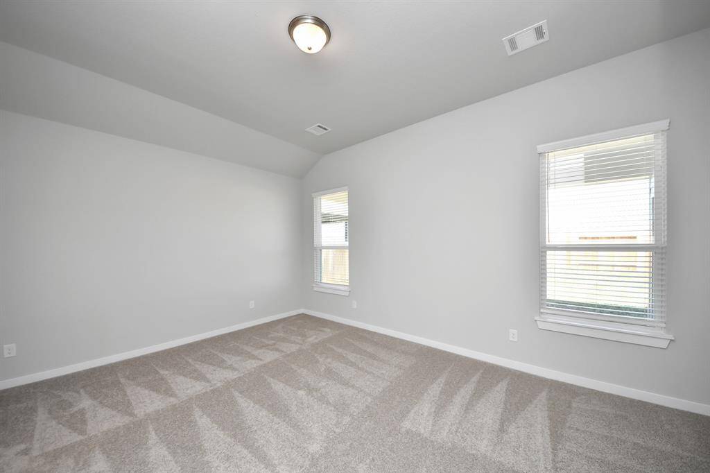 Another perspective unveils a comprehensive view of the serenity and comfort this primary suite offers. Sample photo of completed home with similar floor plan. Actual colors and selections may vary.