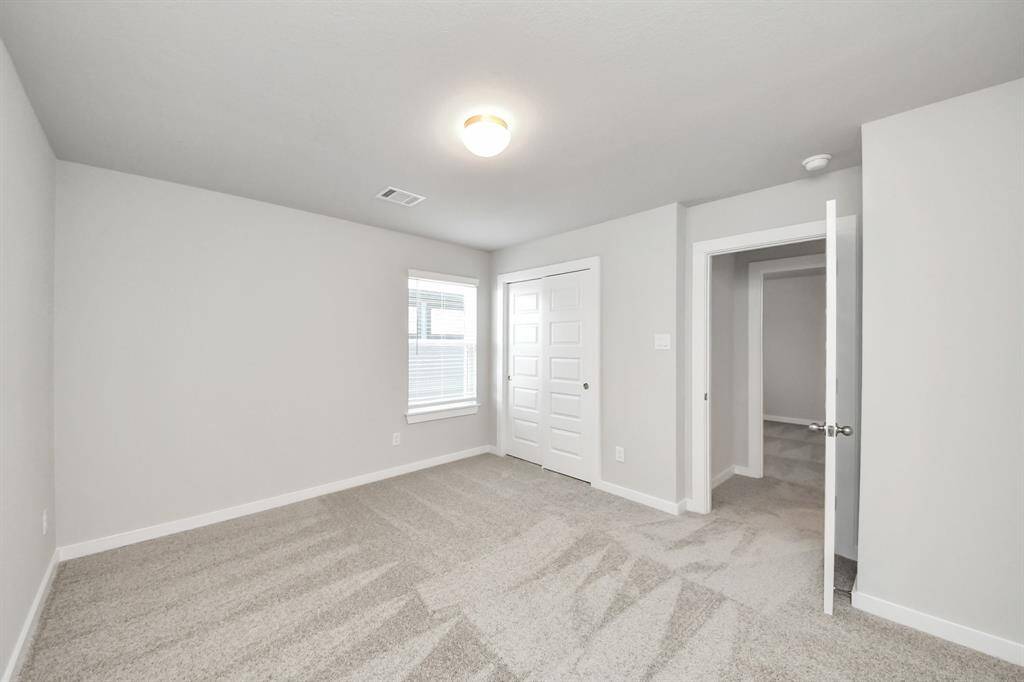 Generously sized secondary bedrooms featuring spacious closets, soft and inviting carpeting underfoot, large windows allowing plenty of natural light, and the added touch of privacy blinds for your personal retreat. Sample photo of completed home with similar floor plan. Actual colors and selections may vary.