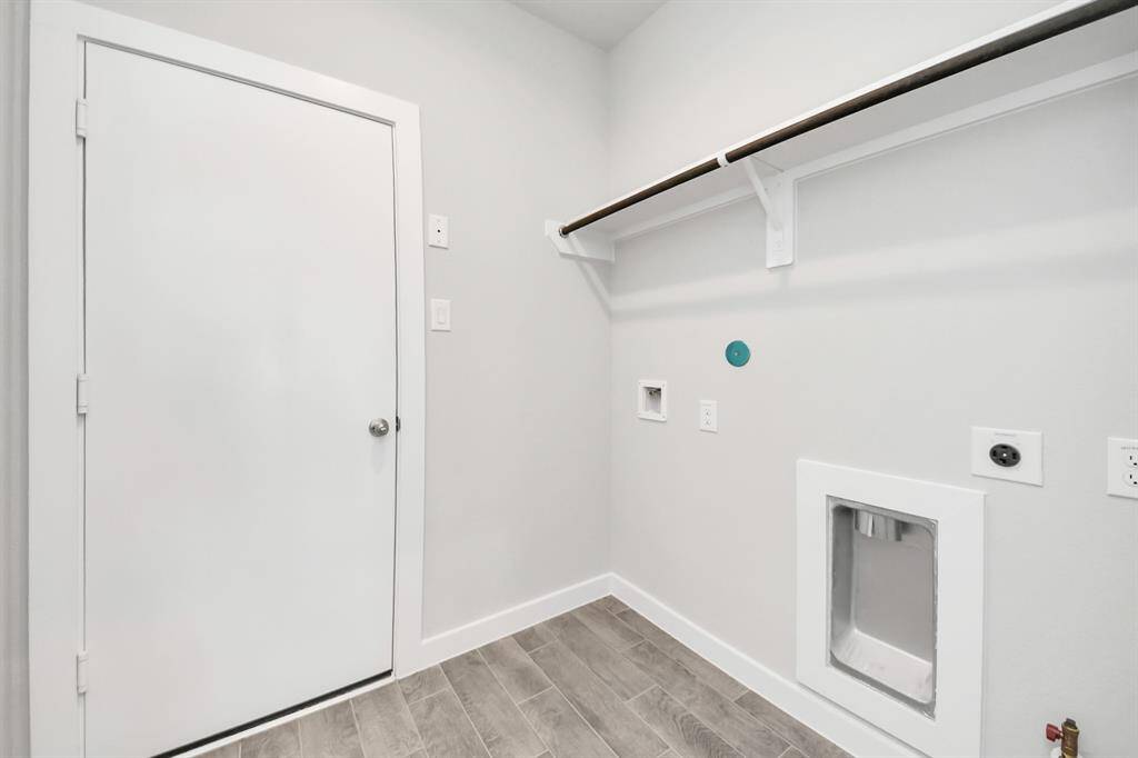 A perfect blend of functionality and comfort. Capture the essence of easy living with a first-floor laundry room, thoughtfully equipped with shelving for effortless organization. Both electric and gas connections available.