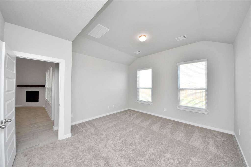 Another perspective unveils a comprehensive view of the serenity and comfort this primary suite offers. Sample photo of completed home with similar floor plan. Actual colors and selections may vary.