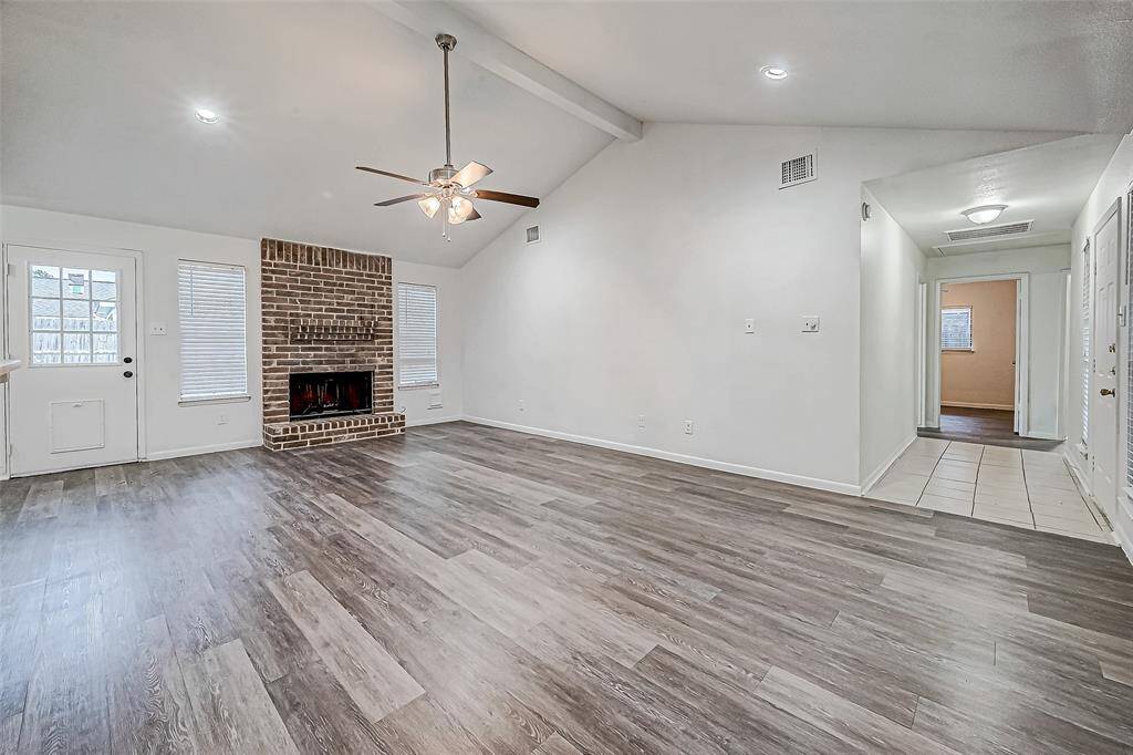 Another view of living room. Note the fireplace and easy access to backyard