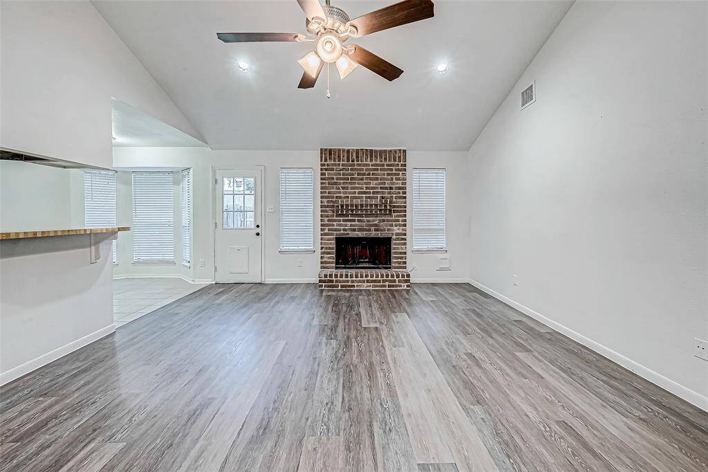 Living flows seamlessly into kitchen. There is even a breakfast bar, perfect for barstools!