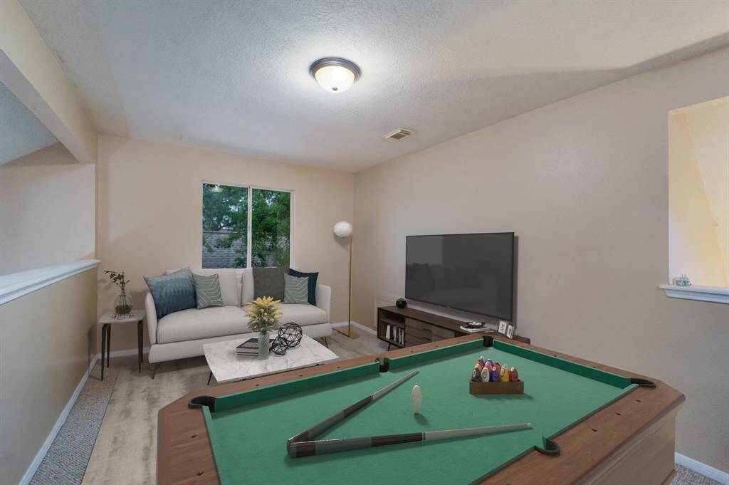 Fantastic upstairs game room that is perfect for entertaining or relaxing. (Virtually Staged)