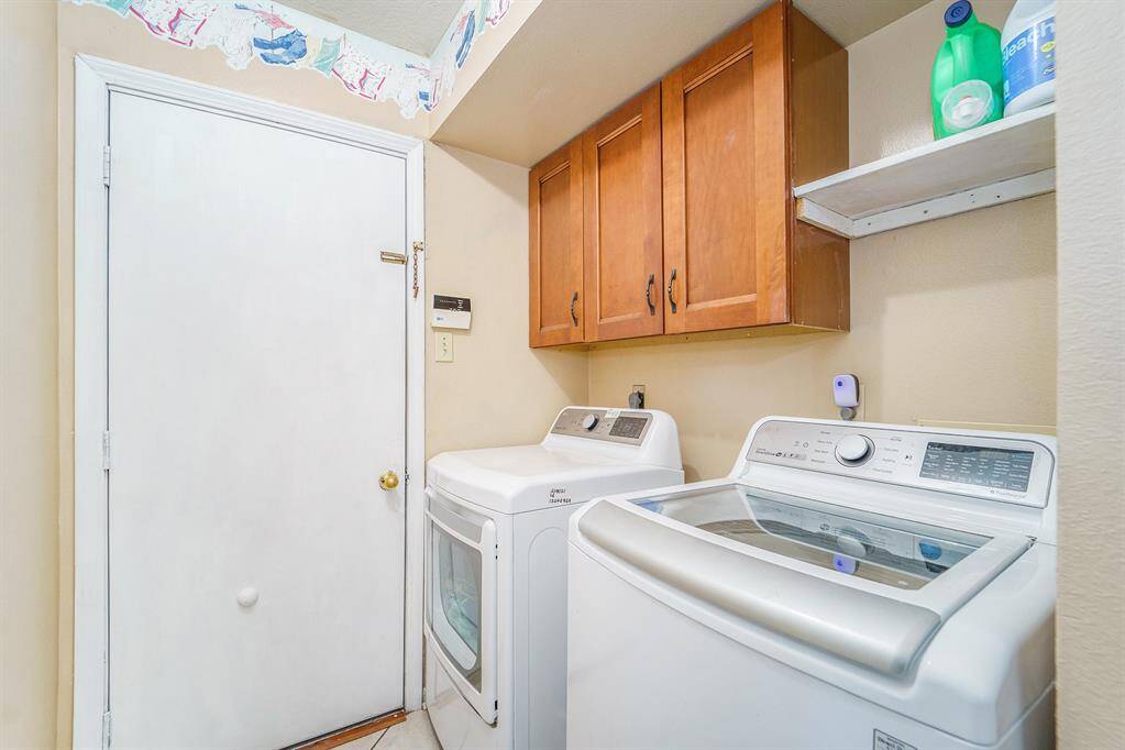 View of the laundry room with access to the garage.