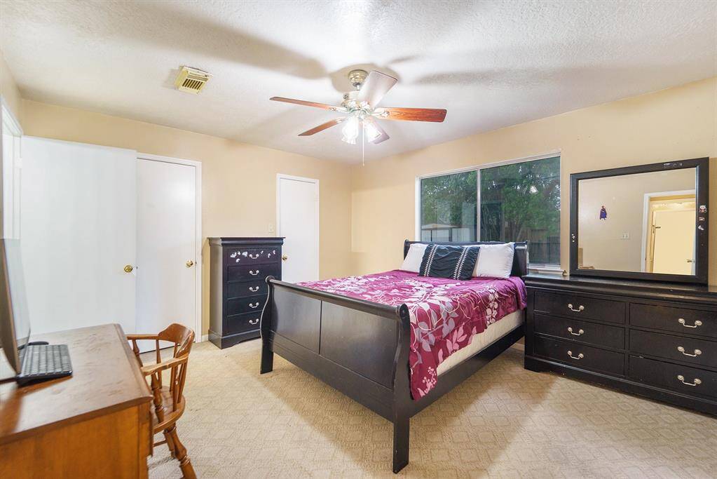 Spacious primary bedroom with views of the backyard.
