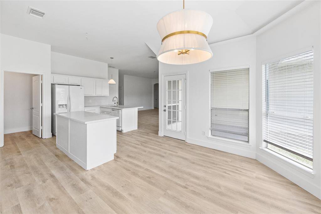 Second view of breakfast nook looking into the open concept kitchen