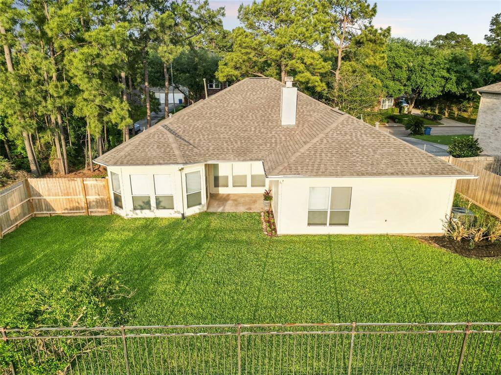 View of large backyard and covered patio
