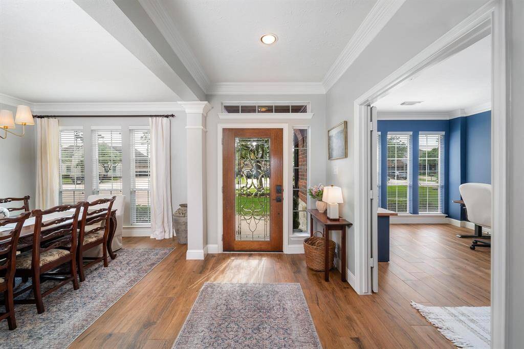 Entryway facing the front door. Dining room on left and office/study on right