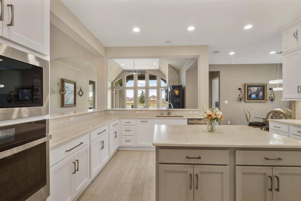 A chef’s dream kitchen featuring high-end stainless steel appliances, generous counter space, and an abundance of cabinetry for all your storage needs.