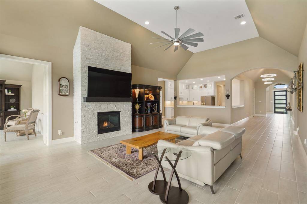 Another angle of the living room reveals a seamless flow into the kitchen, breakfast nook, and a versatile second home office/flex room.