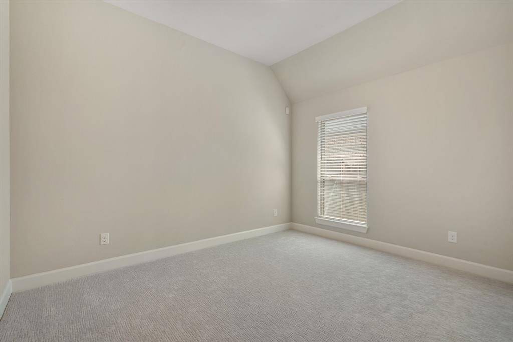 Another spacious bedroom located near the center of the home, with great natural light and a large closet.